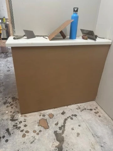 Boarded counter front in a construction training bay during multi-skills course